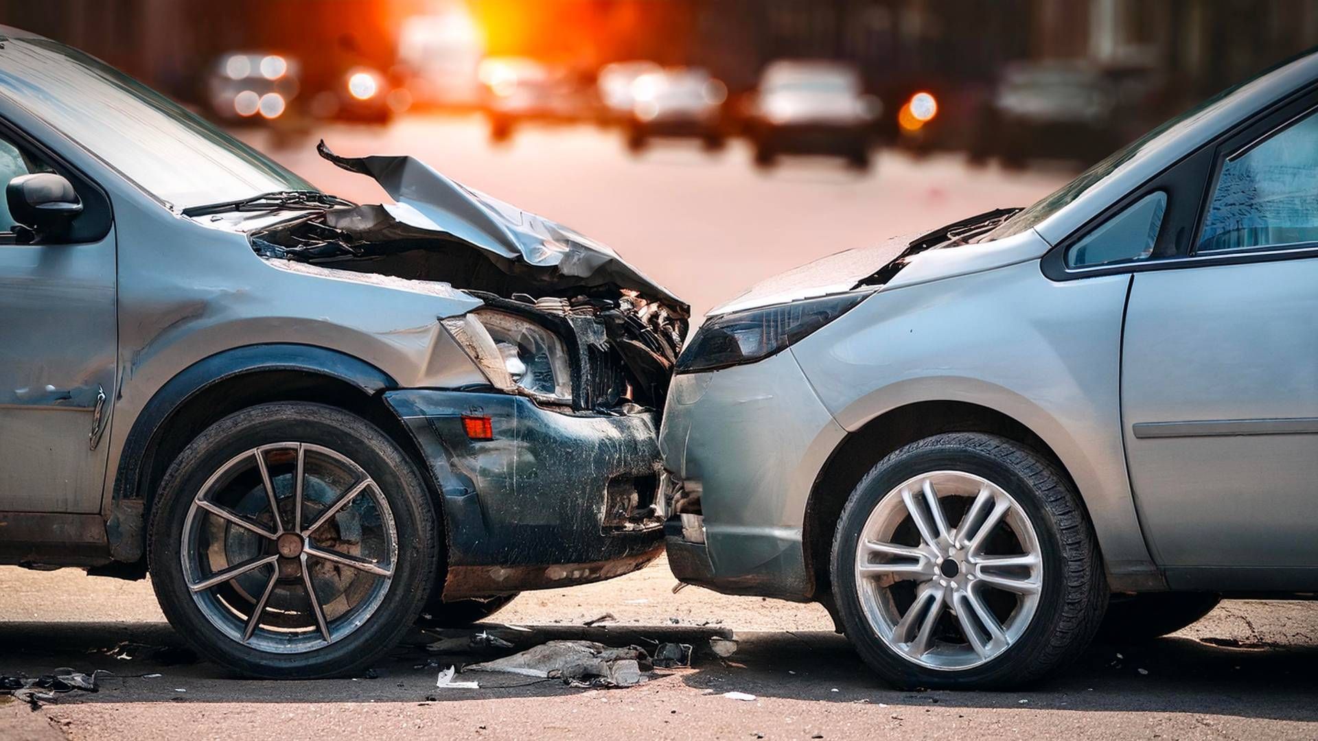 Two cars are involved in a car accident on a city street.