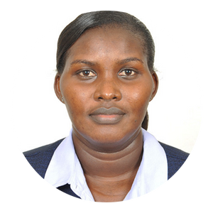 Woman with dark skin, wearing a dark blazer and white shirt, looking directly at the camera.
