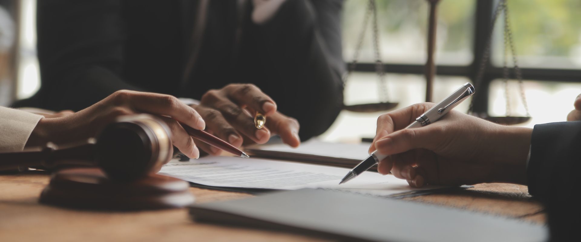 A group of people are sitting at a table signing a document.