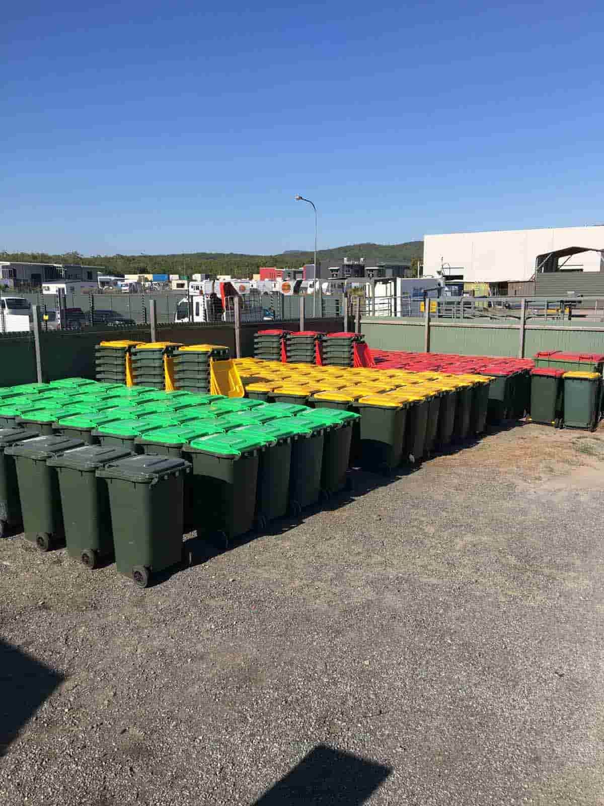 A Bunch Of Trash Cans Are Lined Up In A Parking Lot — Party Bins Pty Ltd In Landsborough, QLD