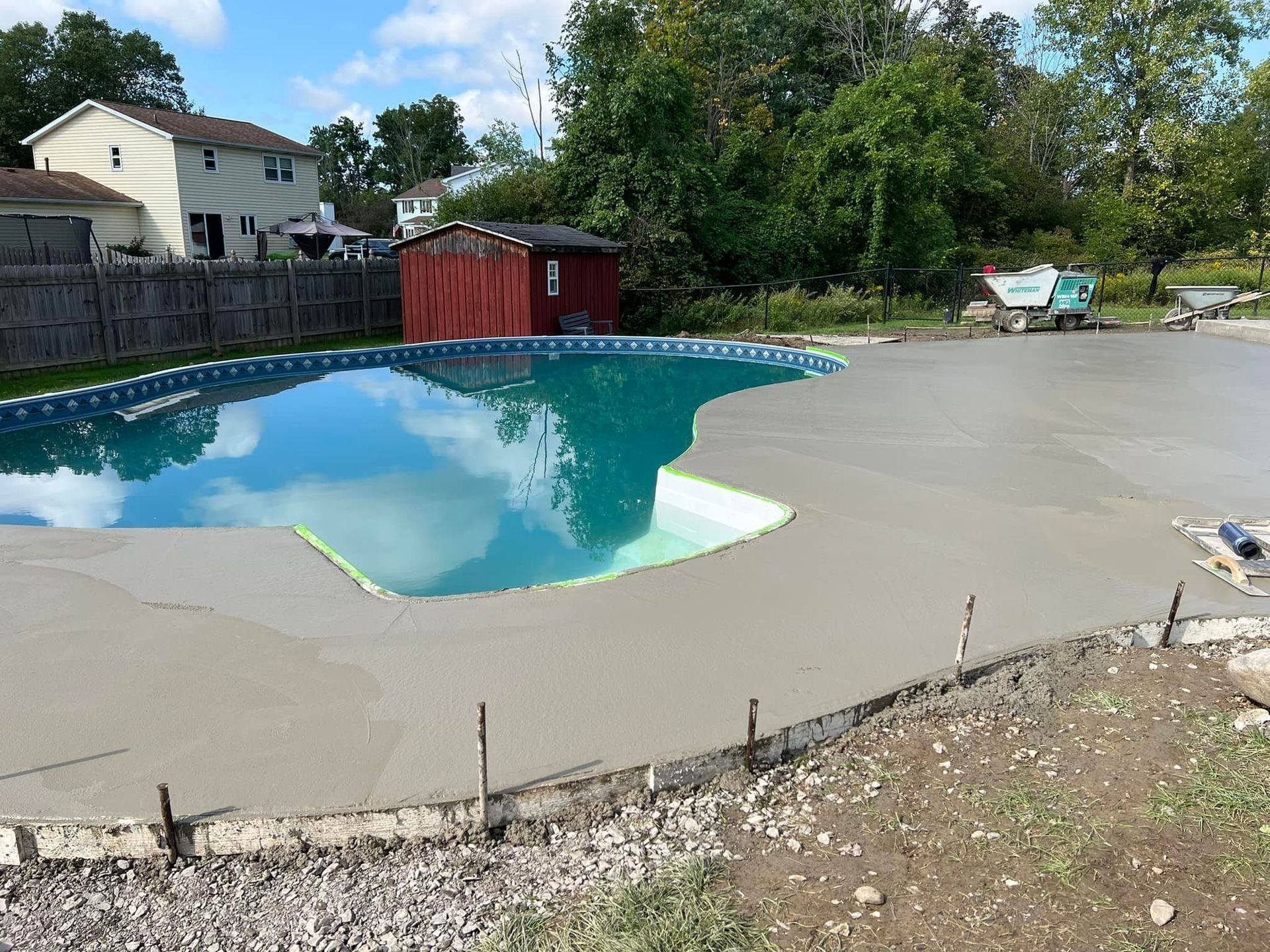 A large swimming pool with a shed in the background