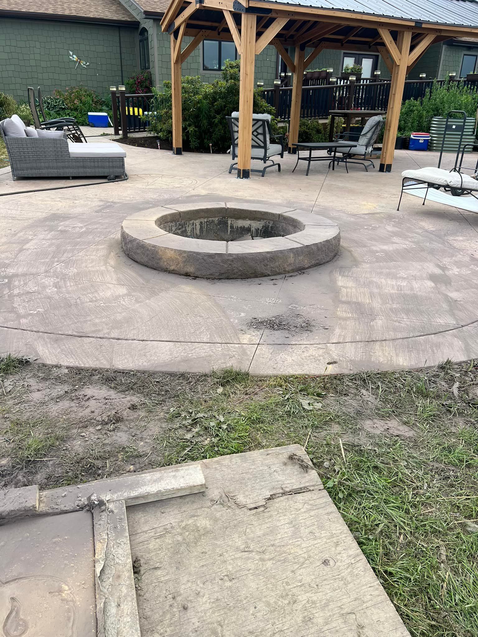 There is a fire pit in the middle of the patio.
