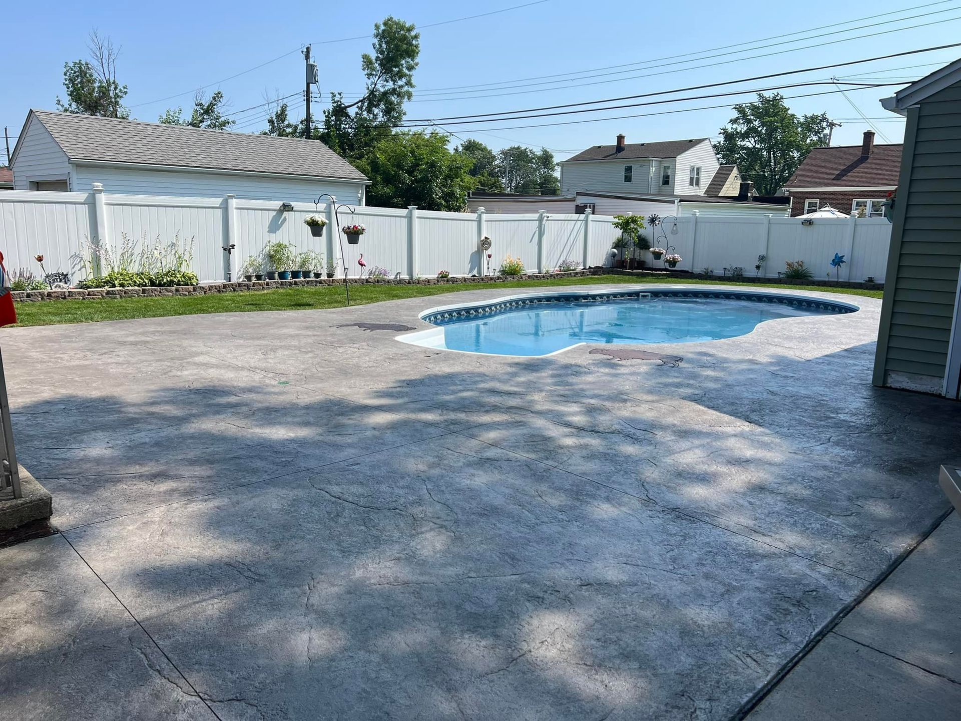 A sunset over a patio with a tree in the foreground