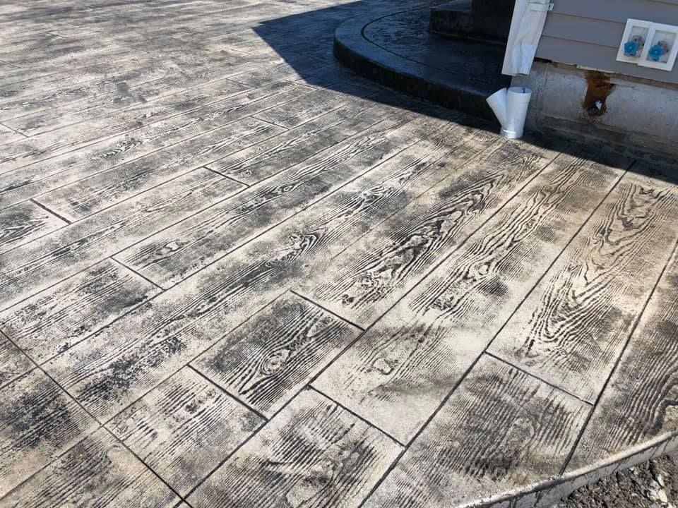 A close up of a concrete walkway being built.