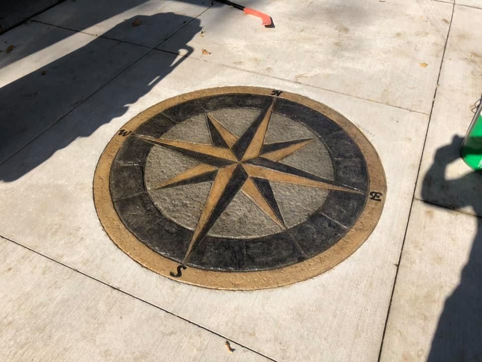 A person is spreading adhesive on a tile floor with a trowel.