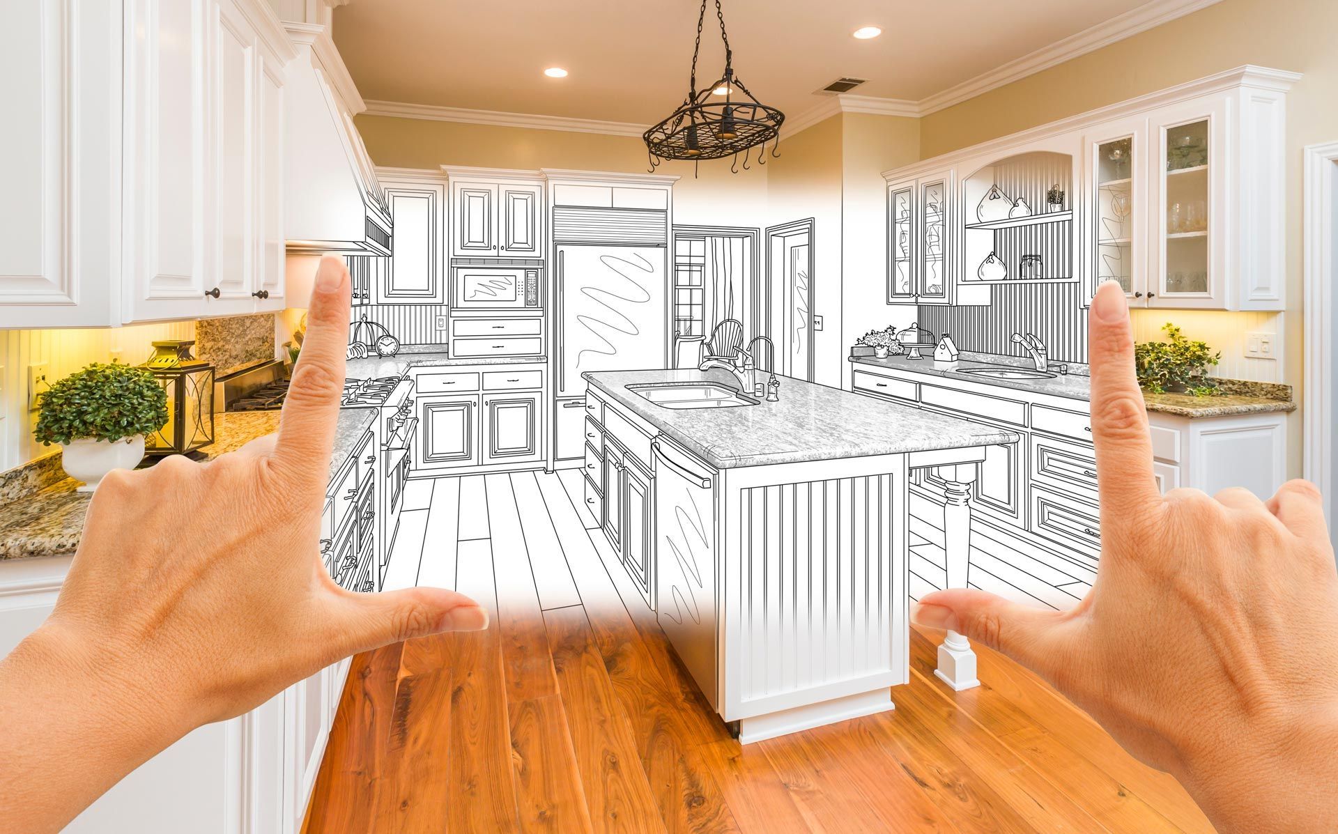 Hands framing a kitchen as part transforms into a detailed renovation sketch