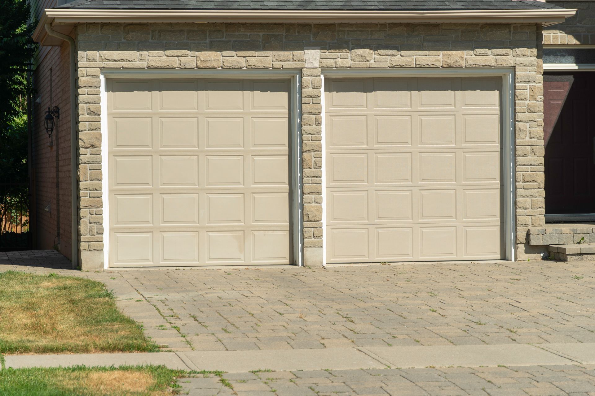 A house with two garage doors in front of it