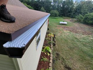 A person is standing on the roof of a house.