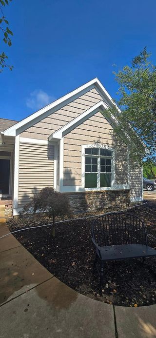 A house with a lot of windows and a blue sky in the background.