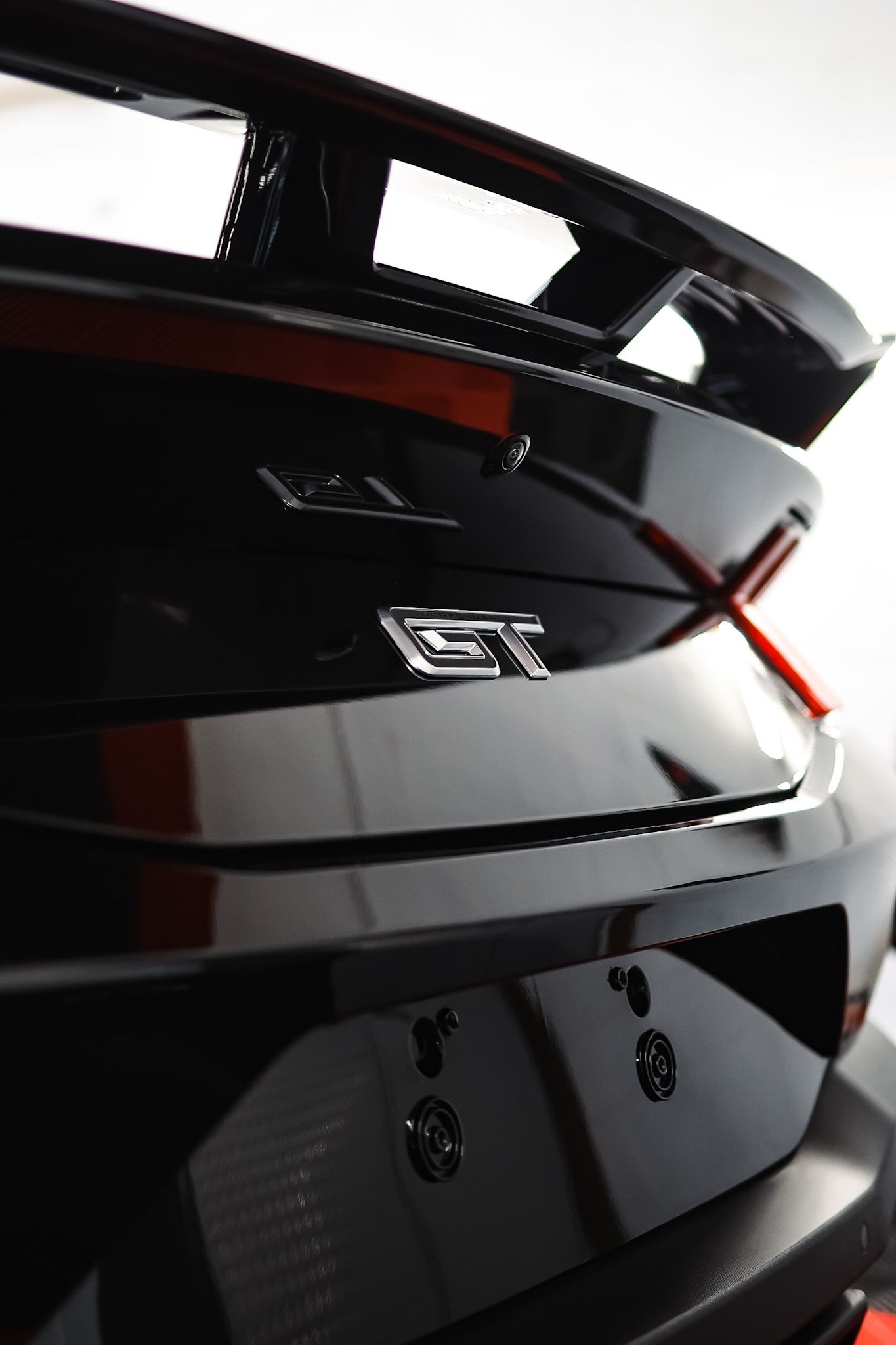 A white mustang convertible is parked on the side of the road.