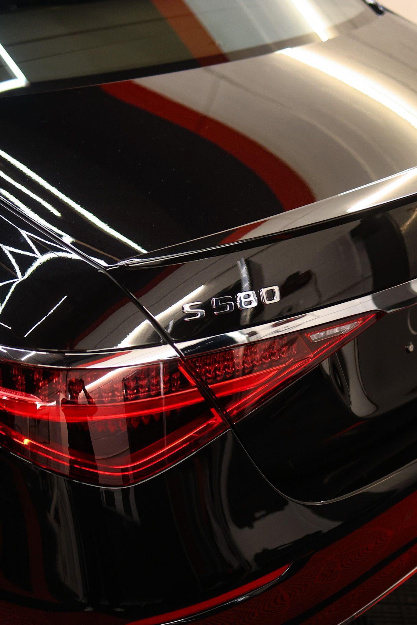 A red chevrolet sedan is parked on the side of the road.