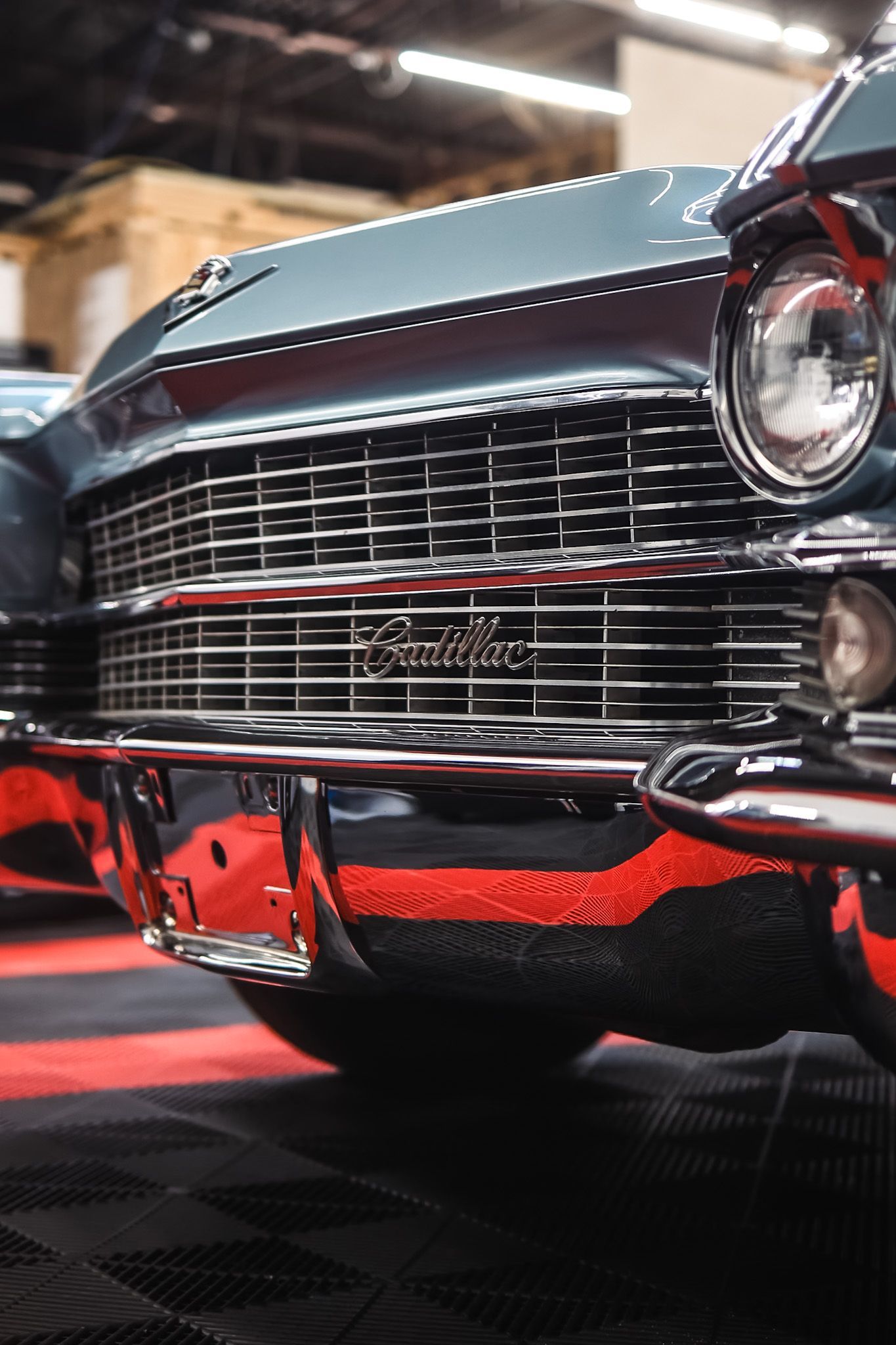 A gray mustang is parked in a parking lot
