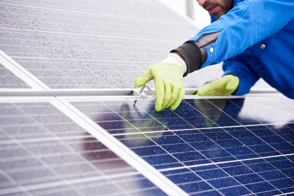Person in Gloves Inspecting Solar Panels — OzEnergi in Maroochydore, QLD
