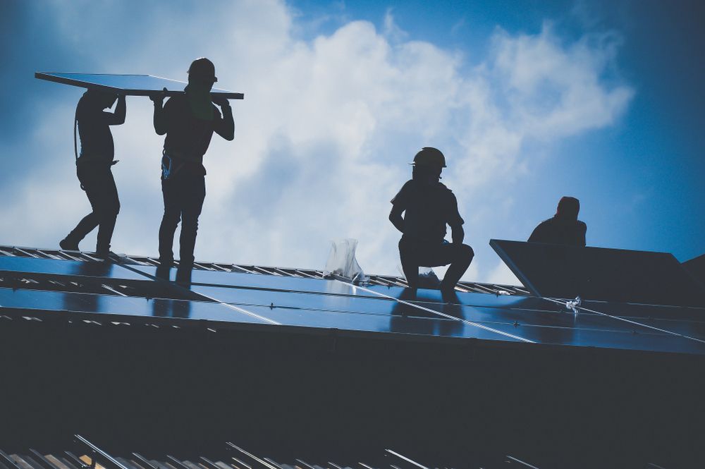 Workers Installing Solar Panels on a Roof — OzEnergi in Maroochydore, QLD