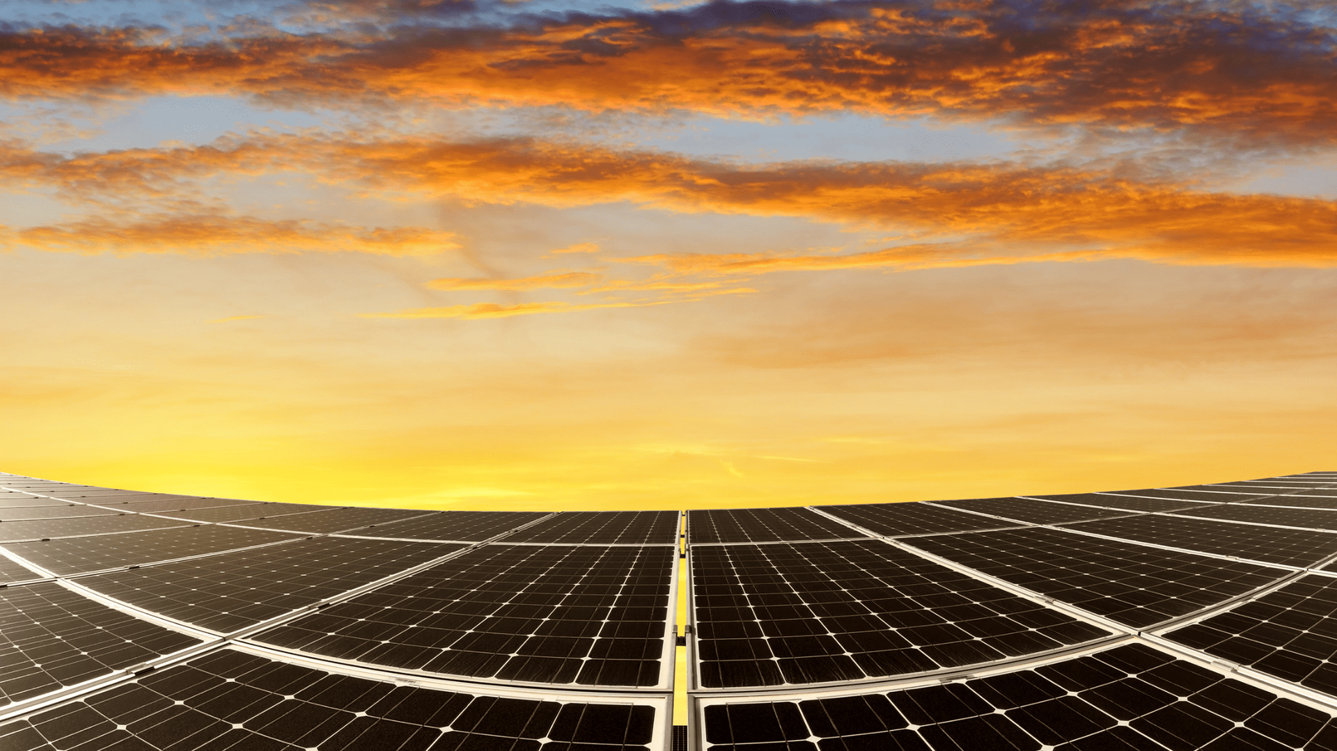 Solar panels at sunset with an orange and blue sky — OzEnergi in Caloundra West, QLD