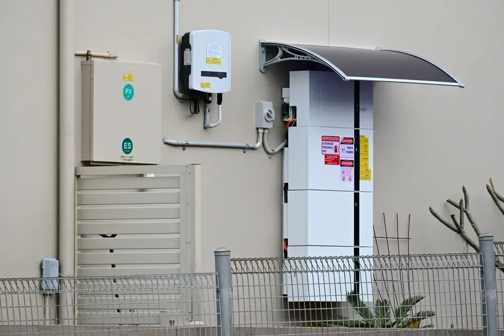 Exterior wall with solar panel, energy storage unit, and electrical components. — OzEnergi in Burleigh Heads, QLD