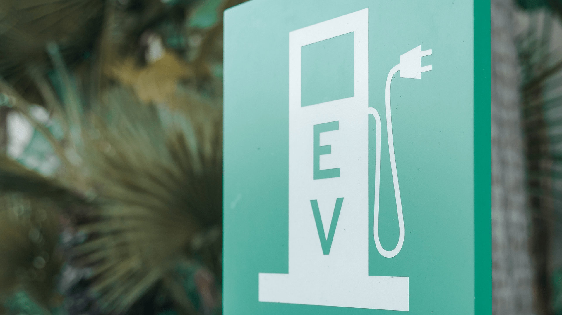 Electric vehicle charging station sign with the letters EV — OzEnergi in Caloundra West, QLD