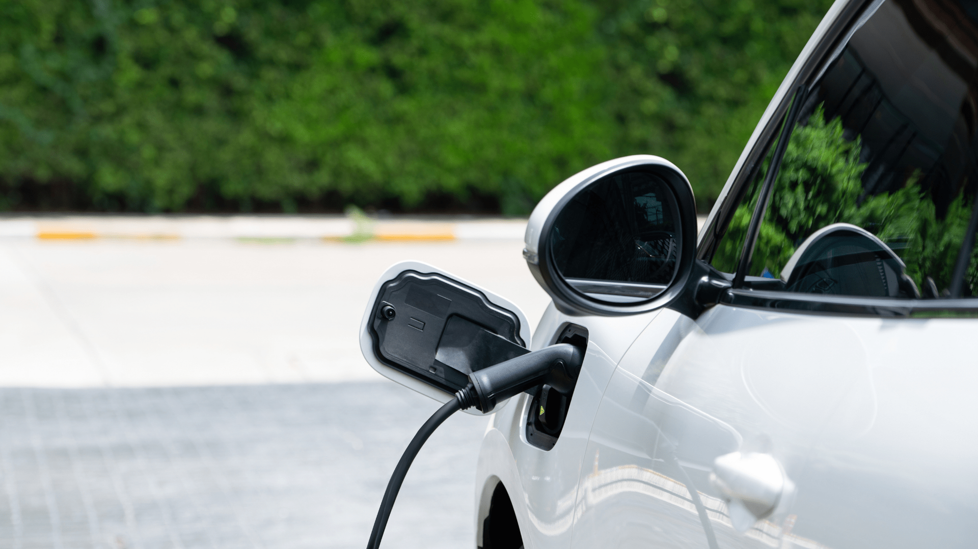 White electric car being charged outdoors — OzEnergi in Caloundra West, QLD