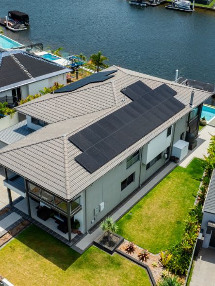 Solar Panels Against a Colorful Sunset Sky — OzEnergi in Caloundra West, QLD