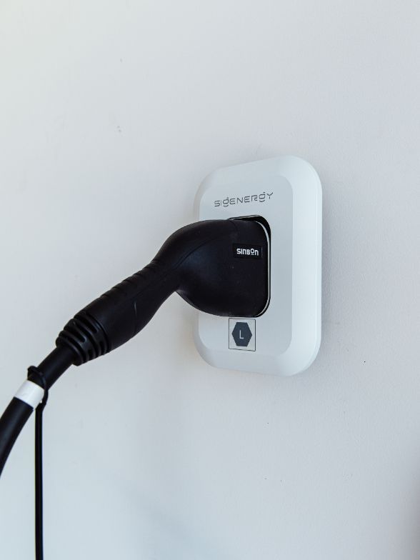 White Electric Car Being Charged Outdoors — OzEnergi in Caloundra West, QLD