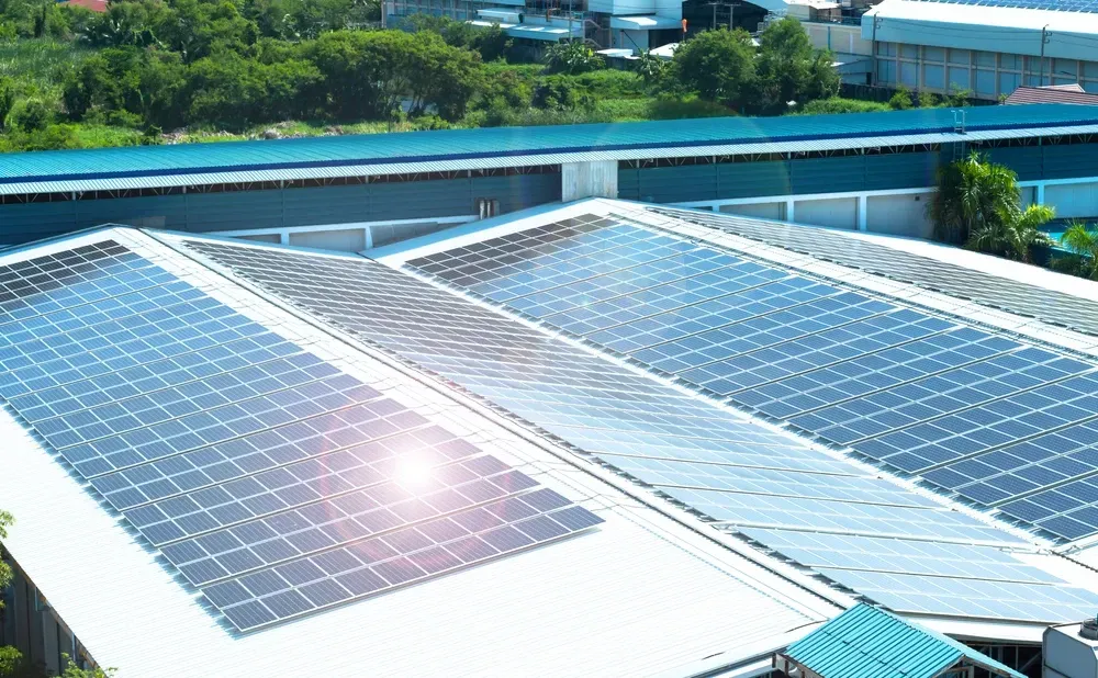 Solar panels on a building roof, reflecting sunlight. — OzEnergi in Burleigh Heads, QLD