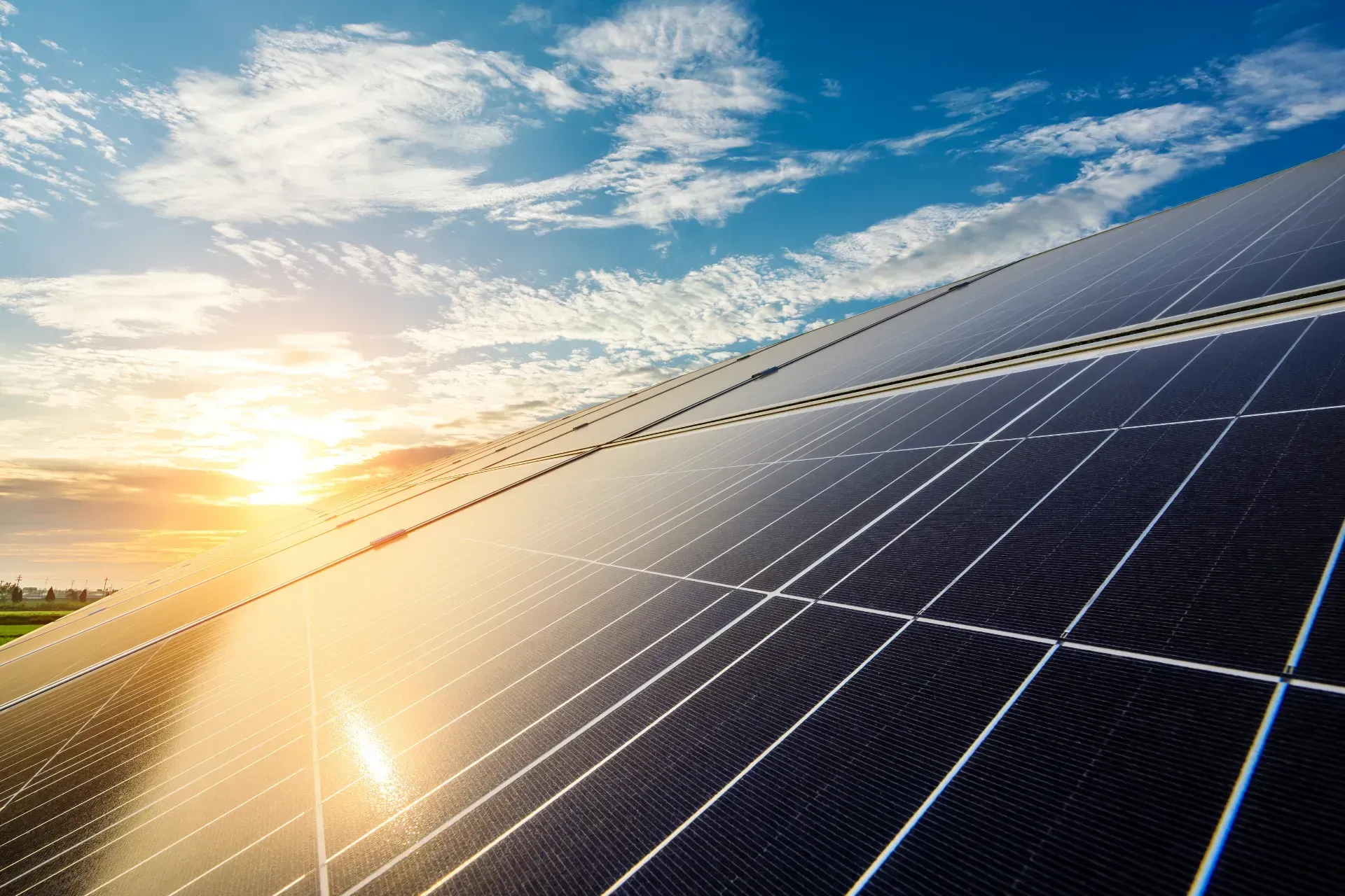 Solar panels angled toward the sun under a blue sky with fluffy clouds. — OzEnergi in Burleigh Heads, QLD