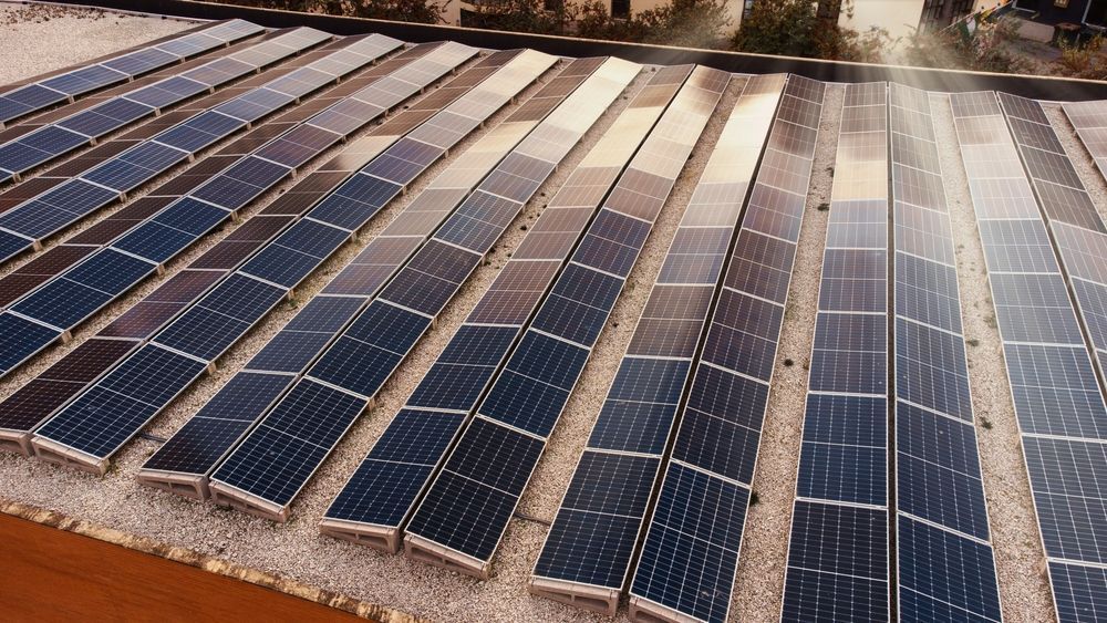 Solar panels arranged in rows, capturing sunlight; outdoor setting. — OzEnergi in Yatala, QLD