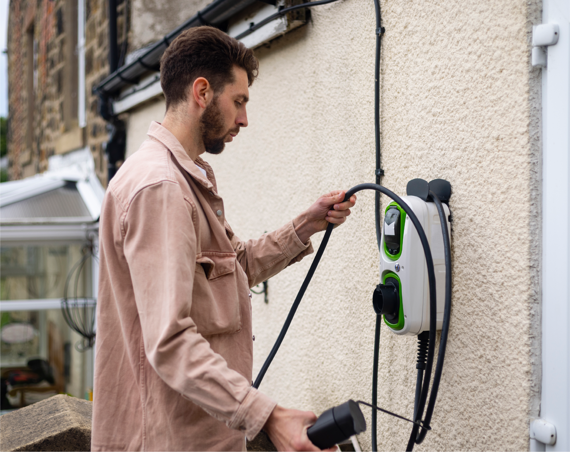 A person is charging an electric car with a charger.