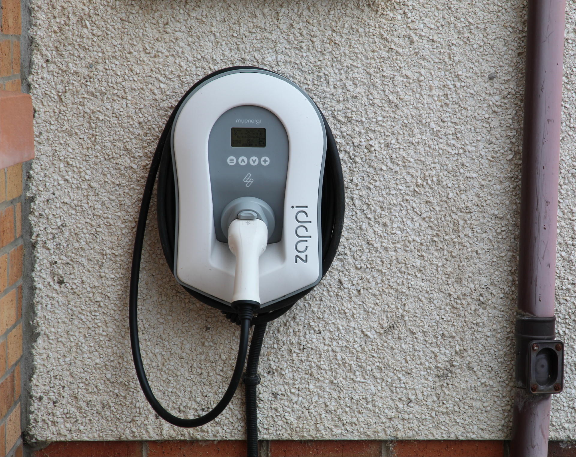 A person is charging an electric car with a charger.