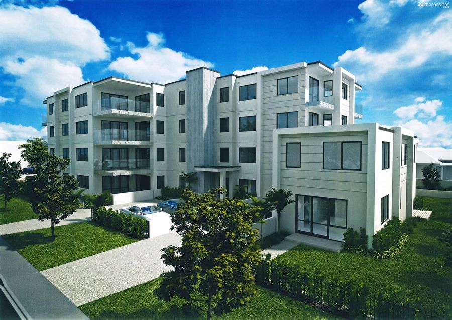 Modern white apartment building with balconies, pool, and landscaping under a blue sky.