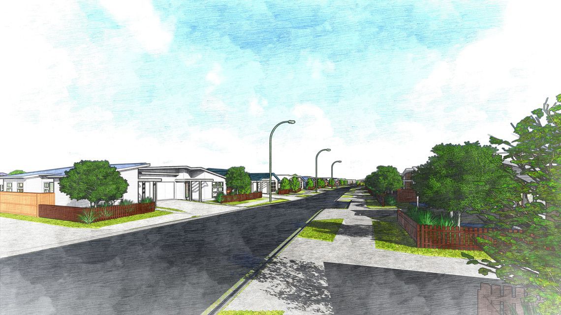 Street view of houses with trees and streetlights, under a blue sky.