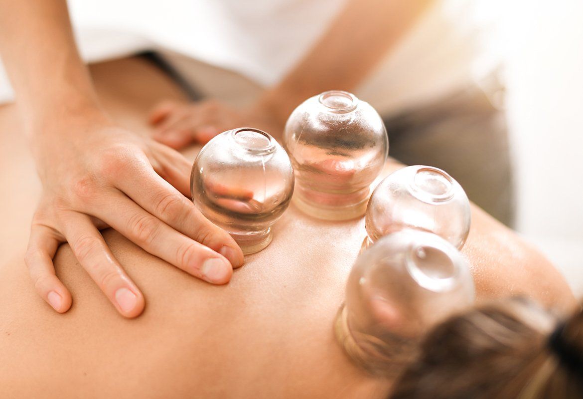 Woman Therapist Hands Giving Cupping Treatment — Troy, NY — Brunswick Esthetics
