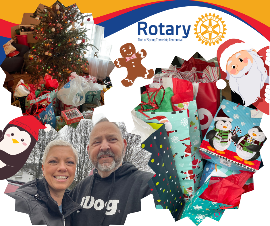 A man and woman are standing in front of a rotary logo