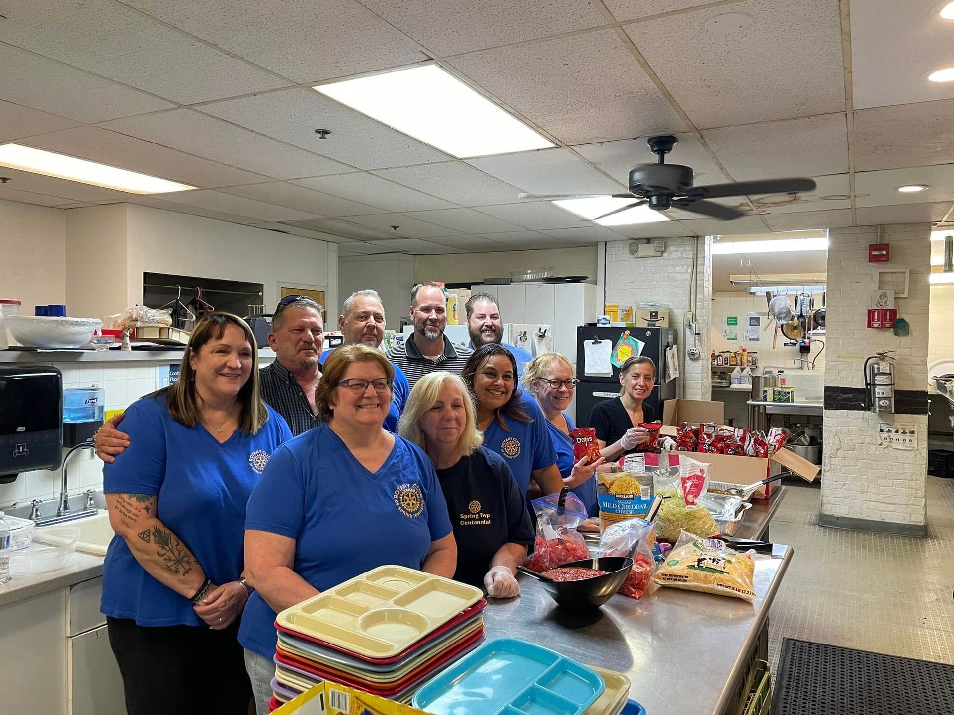 A group of people are posing for a picture in a kitchen.