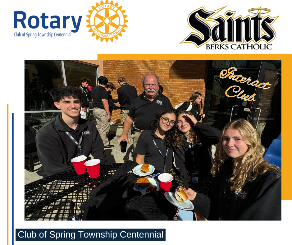 A group of people are sitting at a table eating food.