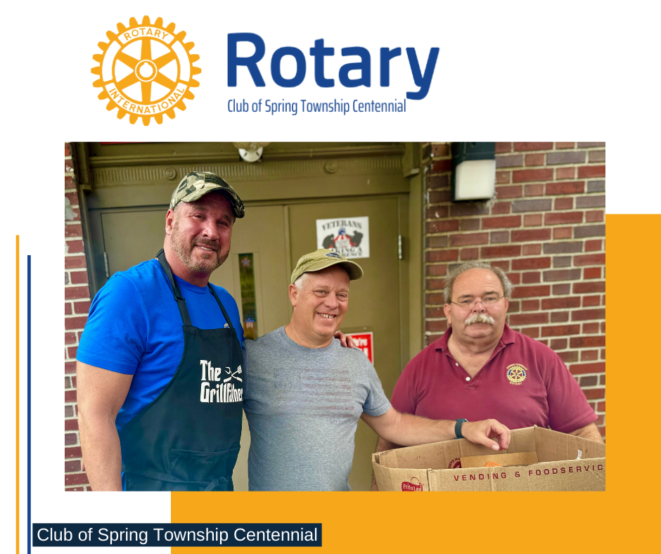 Three men are posing for a picture in front of a brick building for the rotary club of spring township centennial
