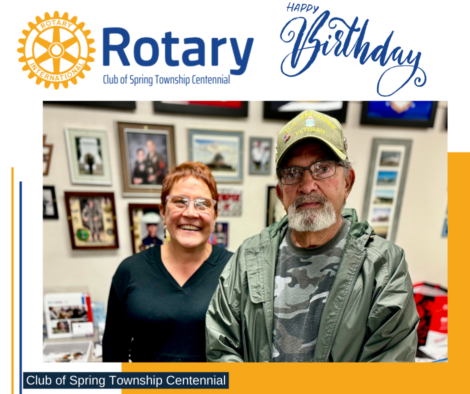 A man and a woman are standing next to each other in a room.