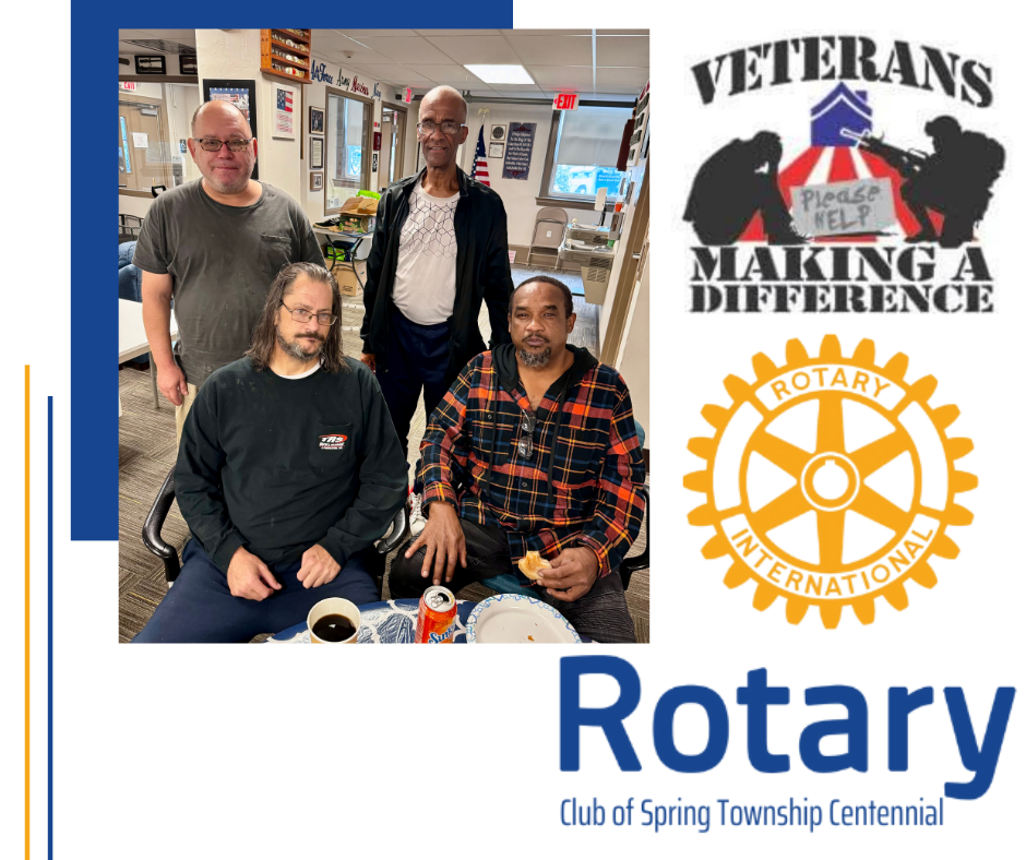 A group of men are sitting at a table in front of a rotary logo