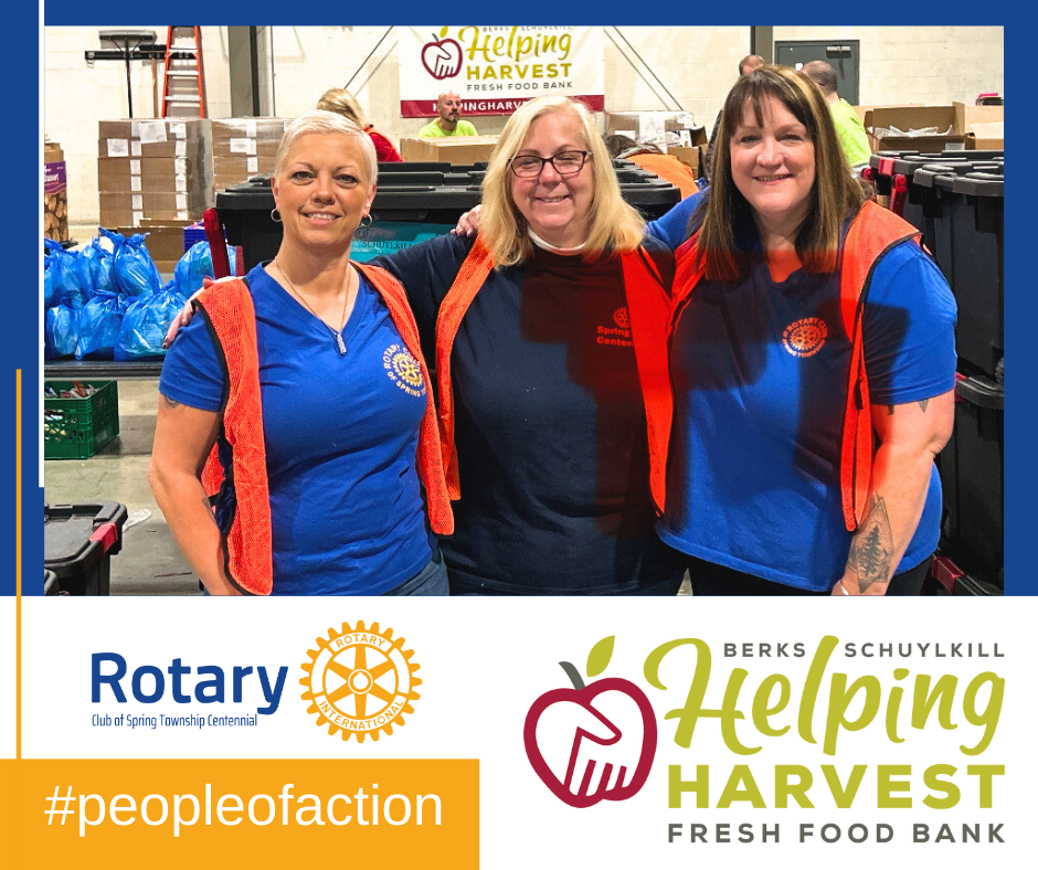 Three women are posing for a picture in front of a sign that says helping harvest fresh food bank.