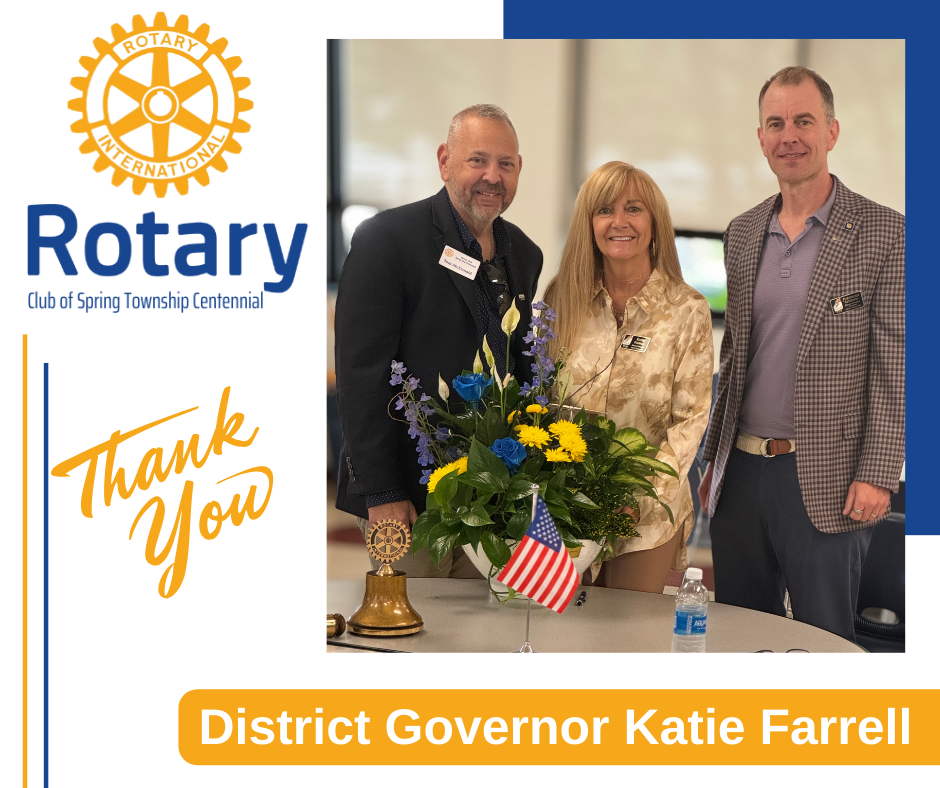 A group of people standing next to each other in front of a bouquet of flowers.