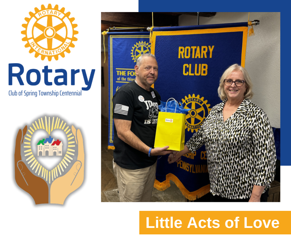 A man and woman are standing in front of a banner that says rotary club