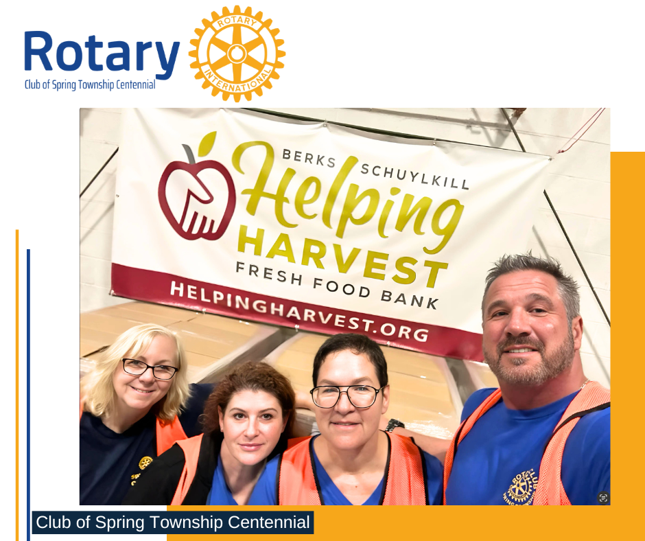 A group of people standing in front of a helping harvest fresh food bank banner.