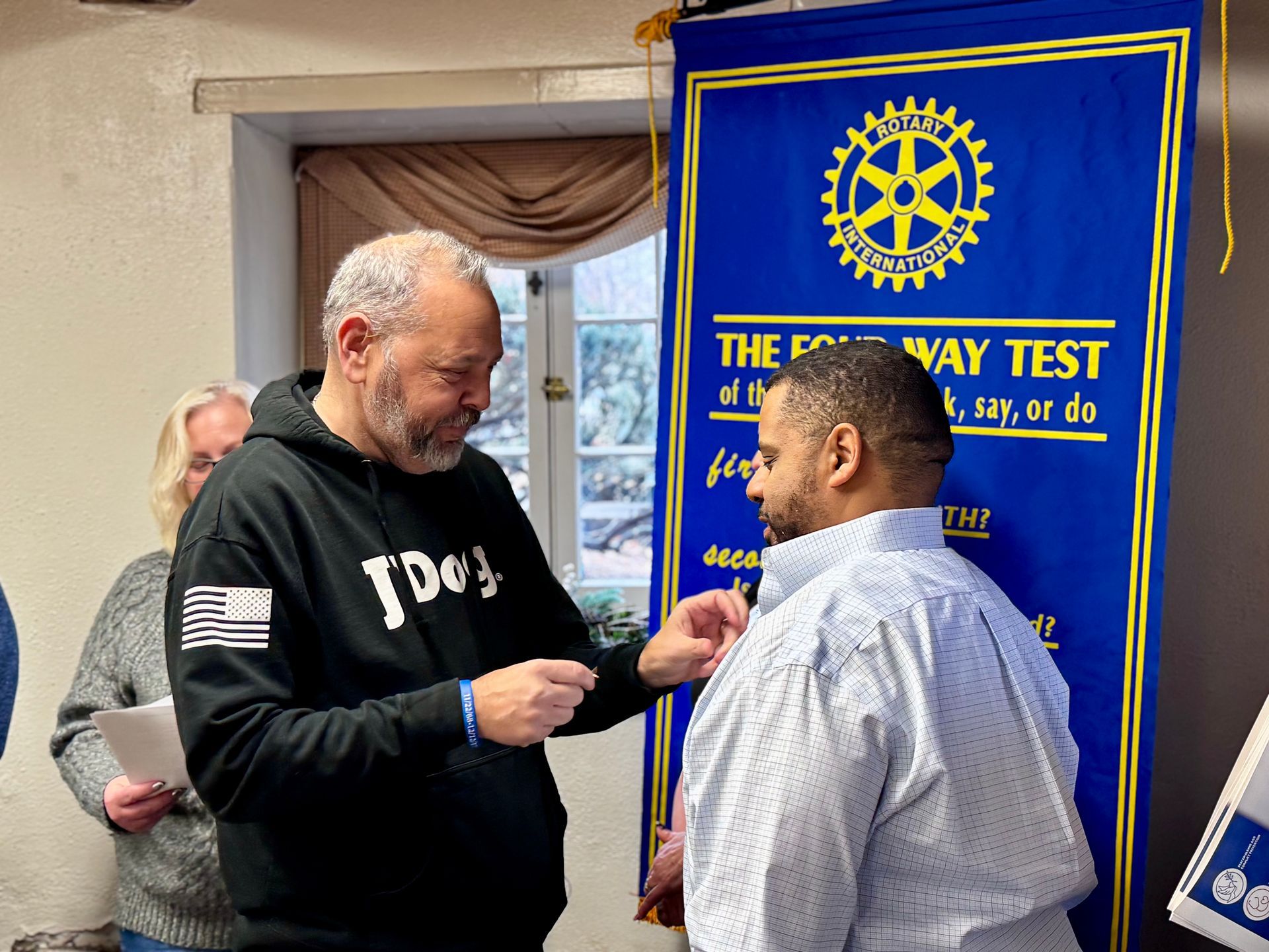 Two men are standing in front of a sign that says the way test