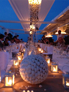Close up photo of the table with white flowers and candles - evening shot