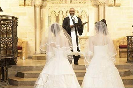 Wedding ceremony of the two brides with the priest