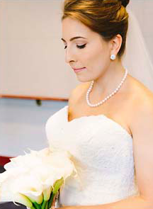 Bride in her white dress and holding her bouquet