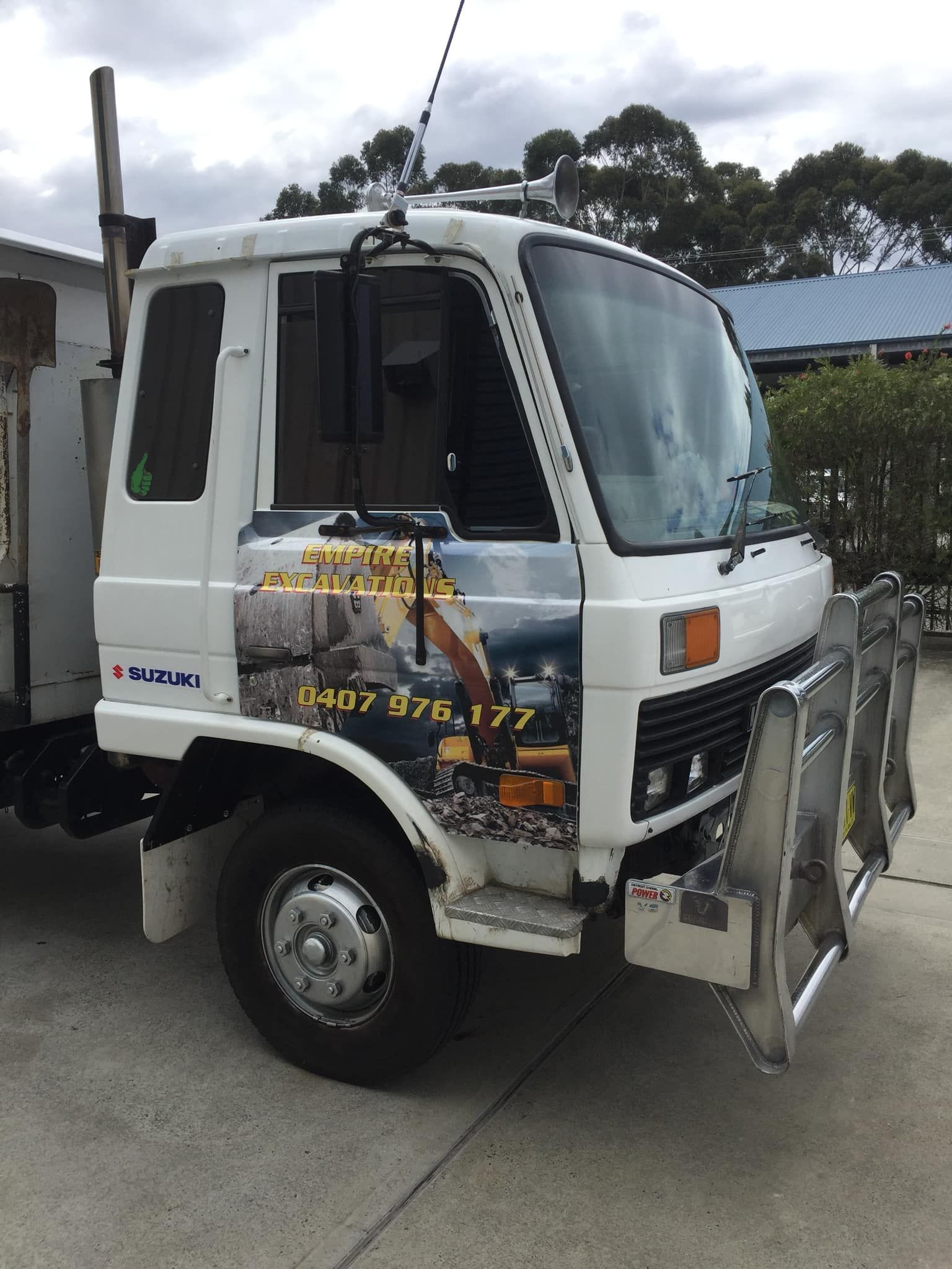 A white truck is parked on the side of the road - Plastiglass Mid North Coast, NSW