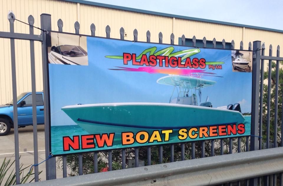 A fence with a banner that says new boat screens - Plastiglass Mid North Coast, NSW
