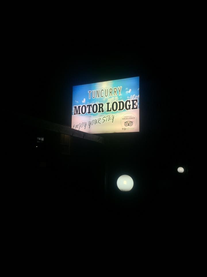 A sign for a motor lodge is lit up at night - Plastiglass Mid North Coast, NSW