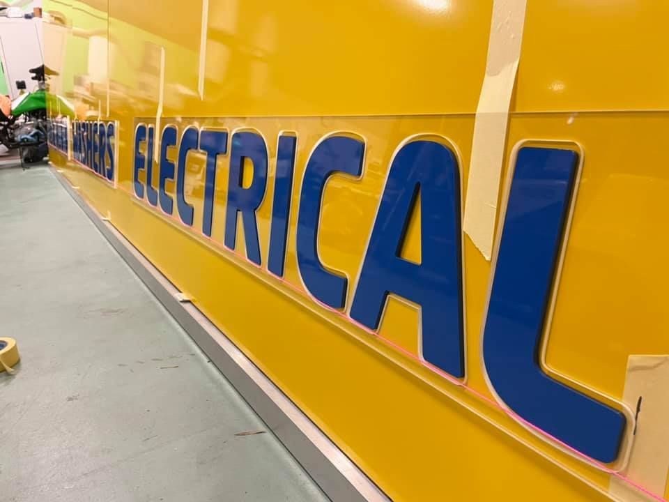 A yellow and blue sign that says electrical on it